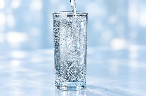 Sparkling water bubbles in a drinking glass