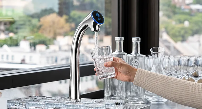 Sparkling water tap dispensing water into a glass