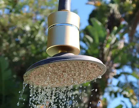 Inline shower filter installed above an overhead shower head